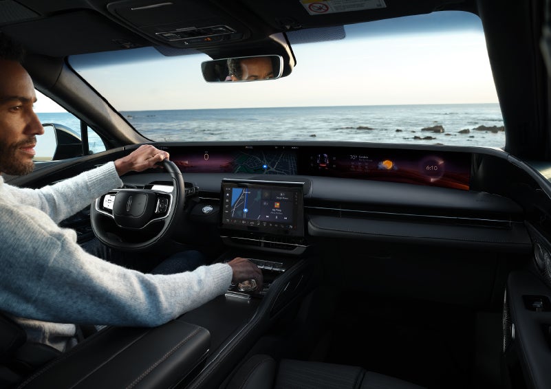 A driver of a parked 2024 Lincoln Nautilus® SUV takes a relaxing moment at a seaside overlook while inside his Nautilus. | Gary Yeomans Lincoln in Daytona Beach FL