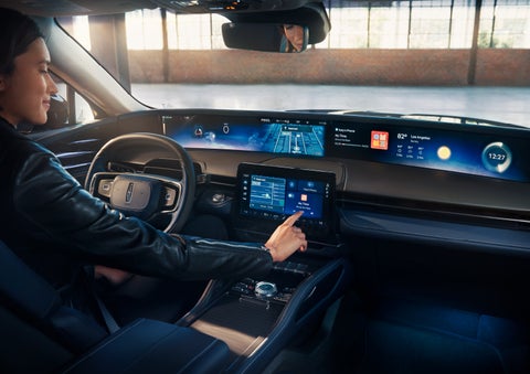 The driver of a 2024 Lincoln Nautilus® SUV interacts with the center touchscreen. | Gary Yeomans Lincoln in Daytona Beach FL