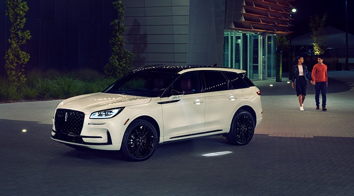 Two people approach a 2024 Lincoln Corsair® SUV featuring the available Jet Appearance Package. | Gary Yeomans Lincoln in Daytona Beach FL