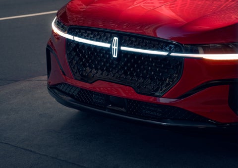 The available front LED light bar and center Lincoln Star logo glow at dusk. | Gary Yeomans Lincoln in Daytona Beach FL