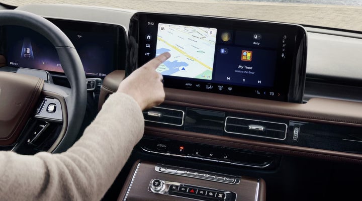 A person is tapping the center display touchscreen of a 2026 Lincoln Aviator® SUV. | Gary Yeomans Lincoln in Daytona Beach FL