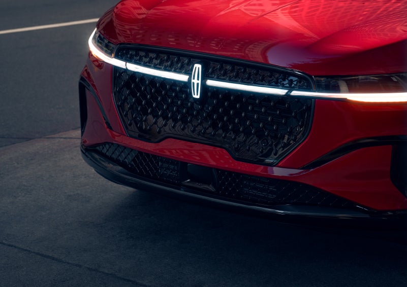 The available front LED light bar and center Lincoln Star logo glow at dusk. | Gary Yeomans Lincoln in Daytona Beach FL