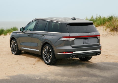 A 2027 Lincoln Aviator® SUV is parked next to sand dunes. | Gary Yeomans Lincoln in Daytona Beach FL