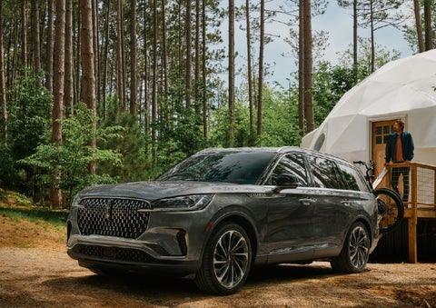 A 2027 Lincoln Aviator® is parked next to a high end glamping site. | Gary Yeomans Lincoln in Daytona Beach FL