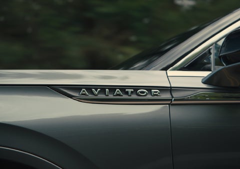 The driver’s side door and fender badging of a gray 2027 Lincoln Aviator® SUV are showcased. | Gary Yeomans Lincoln in Daytona Beach FL