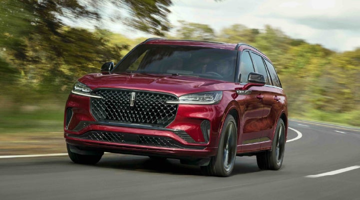 A 2027 Lincoln Aviator® SUV is being driven on a country road | Gary Yeomans Lincoln in Daytona Beach FL