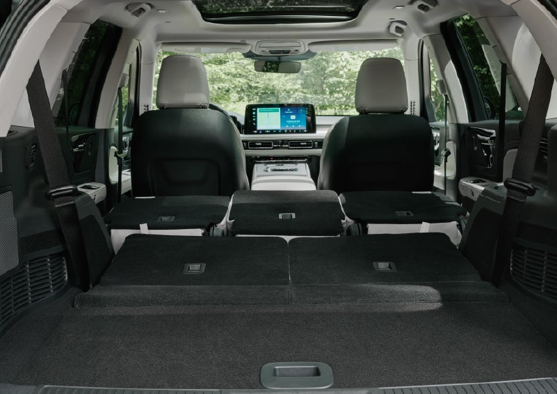 A rear to front view of the interior of a 2027 Lincoln Aviator® Black Label™ SUV shows the third and second rows folded flat | Gary Yeomans Lincoln in Daytona Beach FL