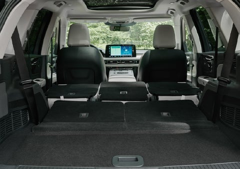 A rear to front view of the interior of a 2027 Lincoln Aviator® Black Label™ SUV shows the third and second rows folded flat | Gary Yeomans Lincoln in Daytona Beach FL