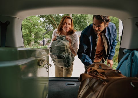 A couple loads luggage into the rear of a 2027 Lincoln Aviator® Black Label™ SUV..e 202 | Gary Yeomans Lincoln in Daytona Beach FL