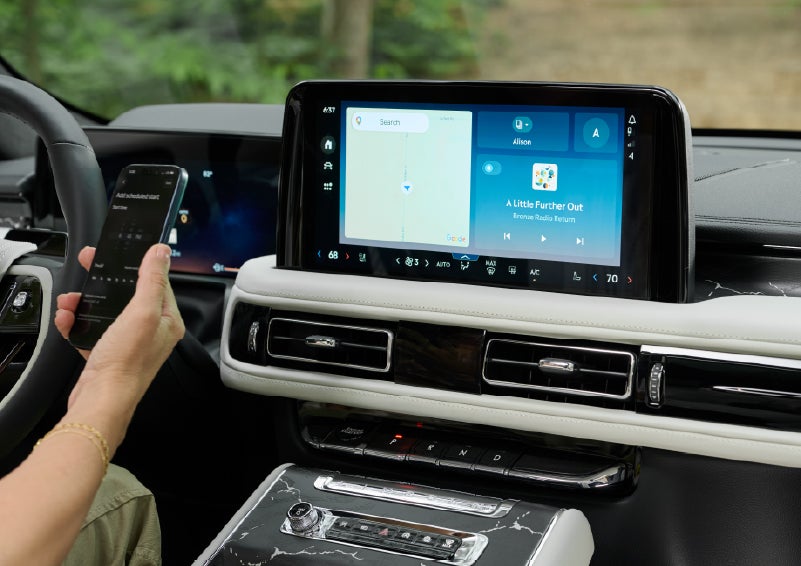 A person pairs thier phone with the center touchscreen of a 2027 Lincoln Aviator® Black Label™ SUV | Gary Yeomans Lincoln in Daytona Beach FL